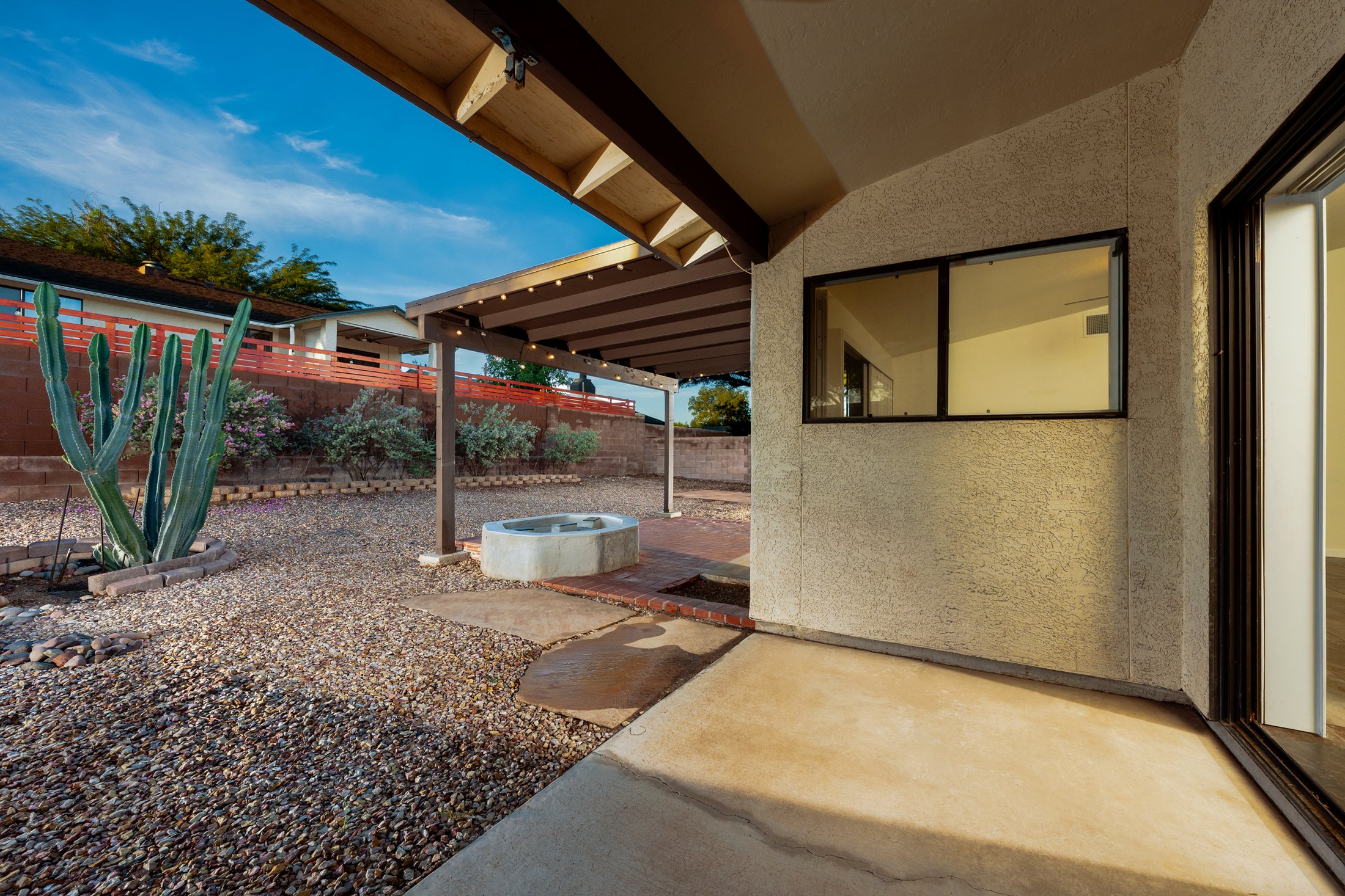 Covered patio looking onto the gravel yard and saguaro.