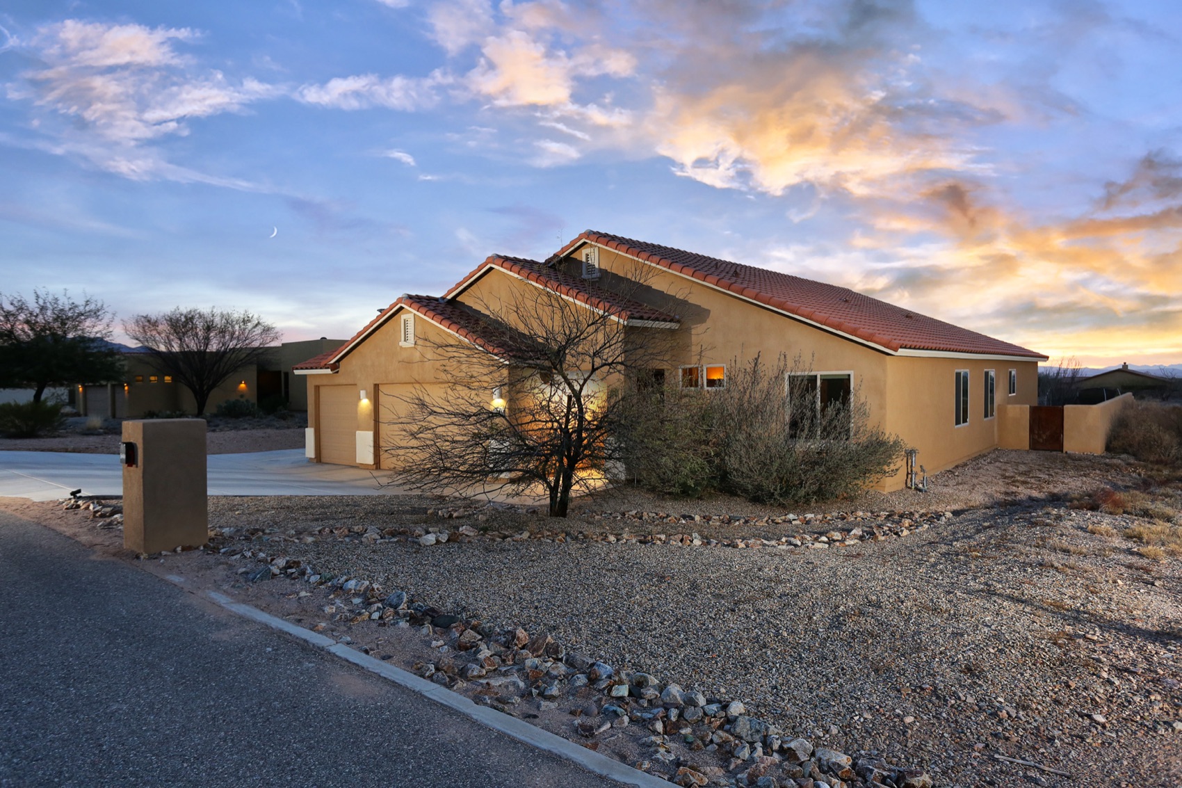Ranch home under dramatic sunset clouds