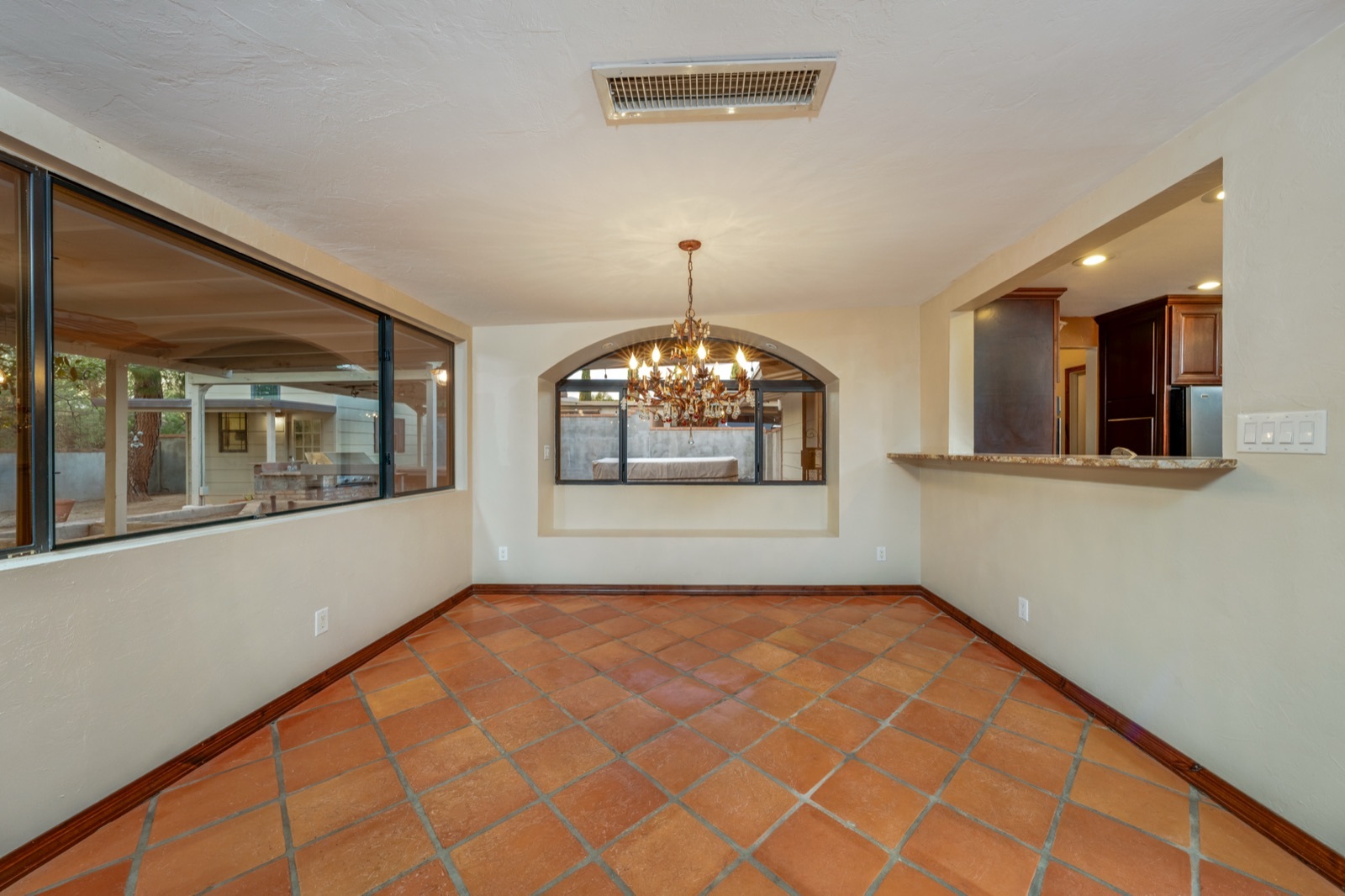 Unfurnished dining room beside a large window facing the covered patio