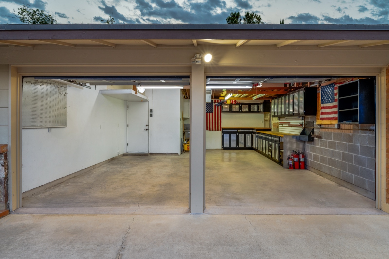Two-bay garage with cabinets and space for tools