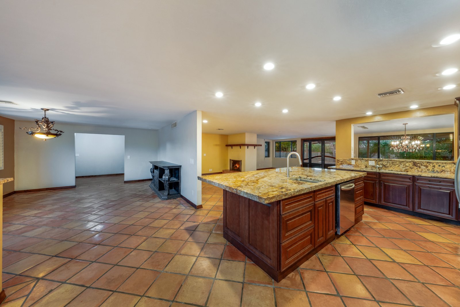 View across the kitchen island toward the living and dining spaces