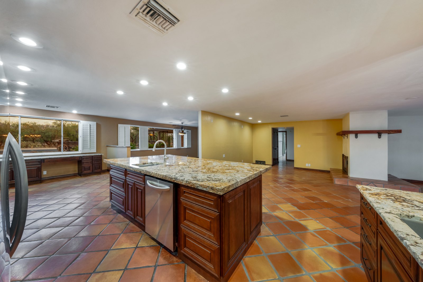Side view of the large kitchen island and open adjoining room