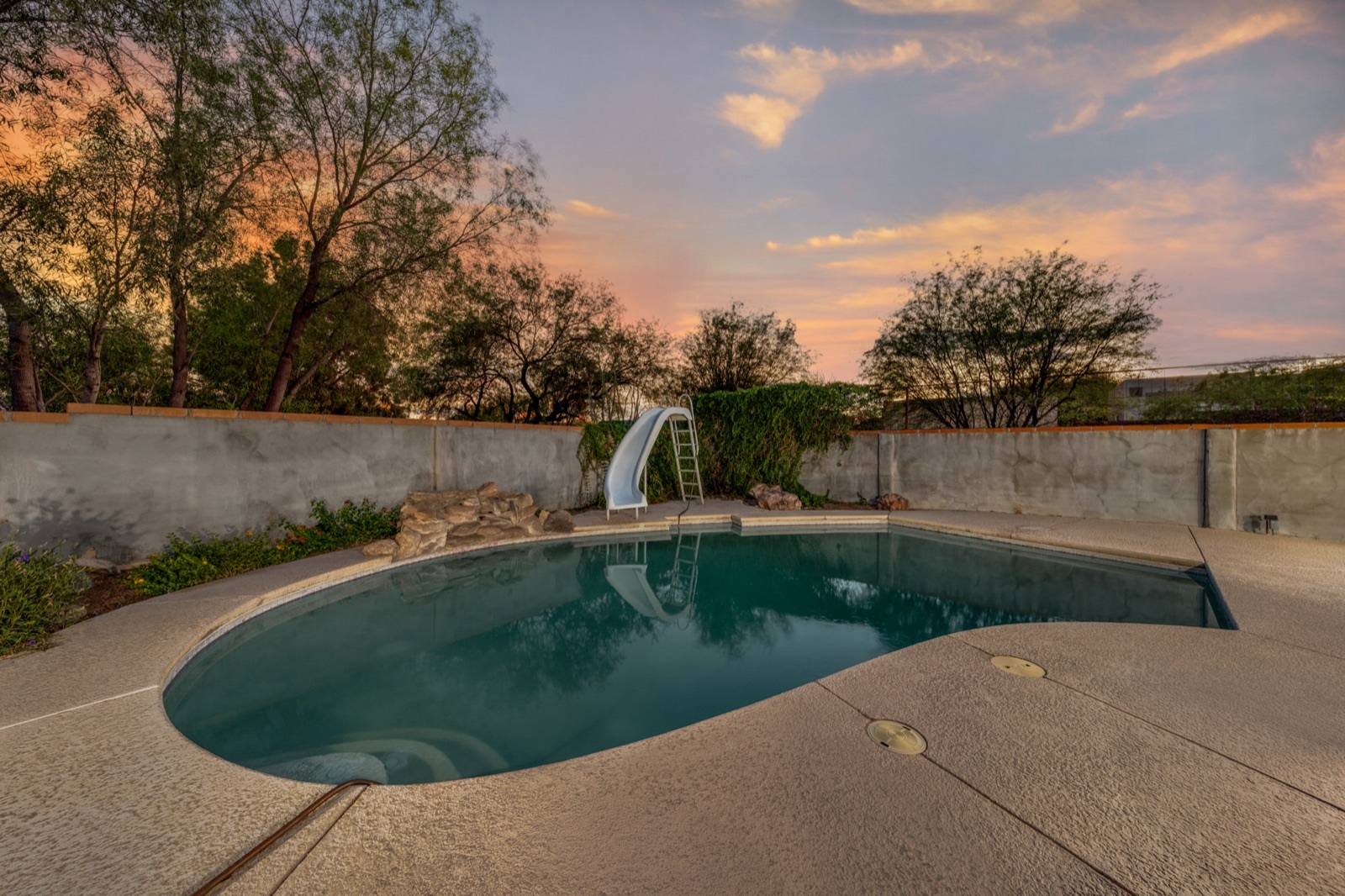 Swimming pool and surrounding deck at dusk