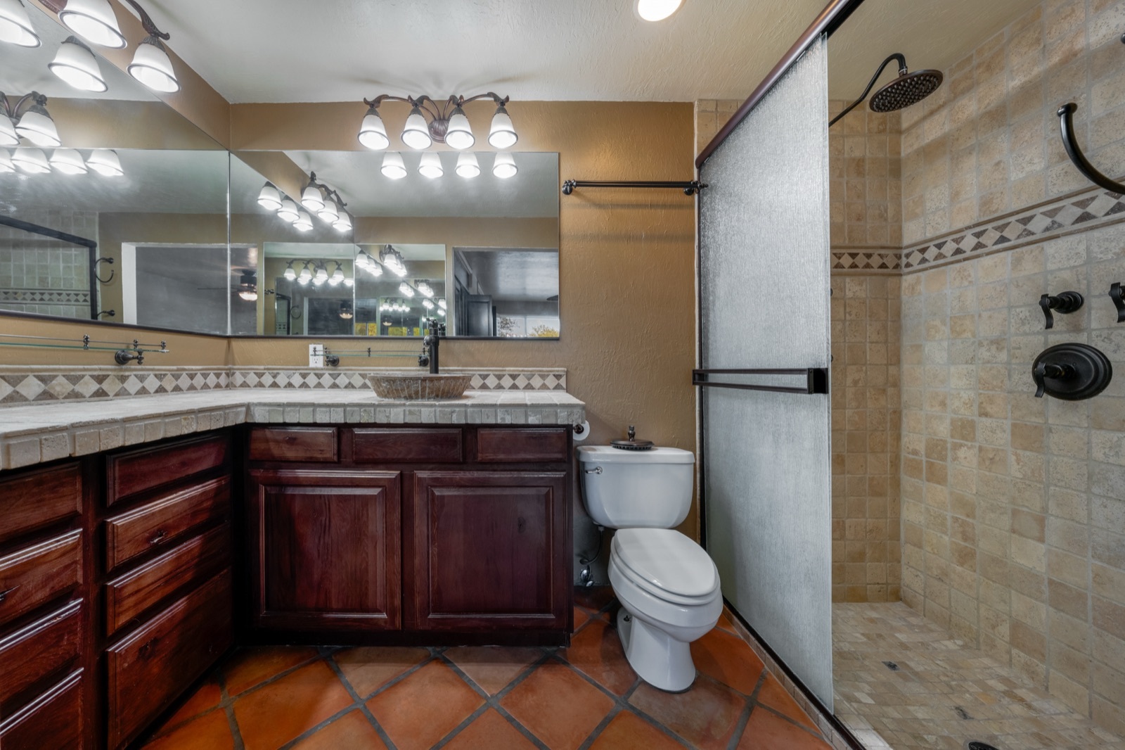 Primary bathroom vanity and glass shower enclosure