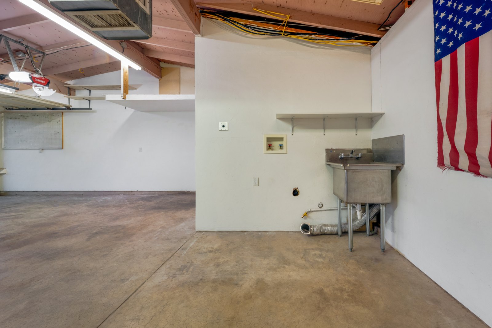 Utility area with a sink and concrete floor
